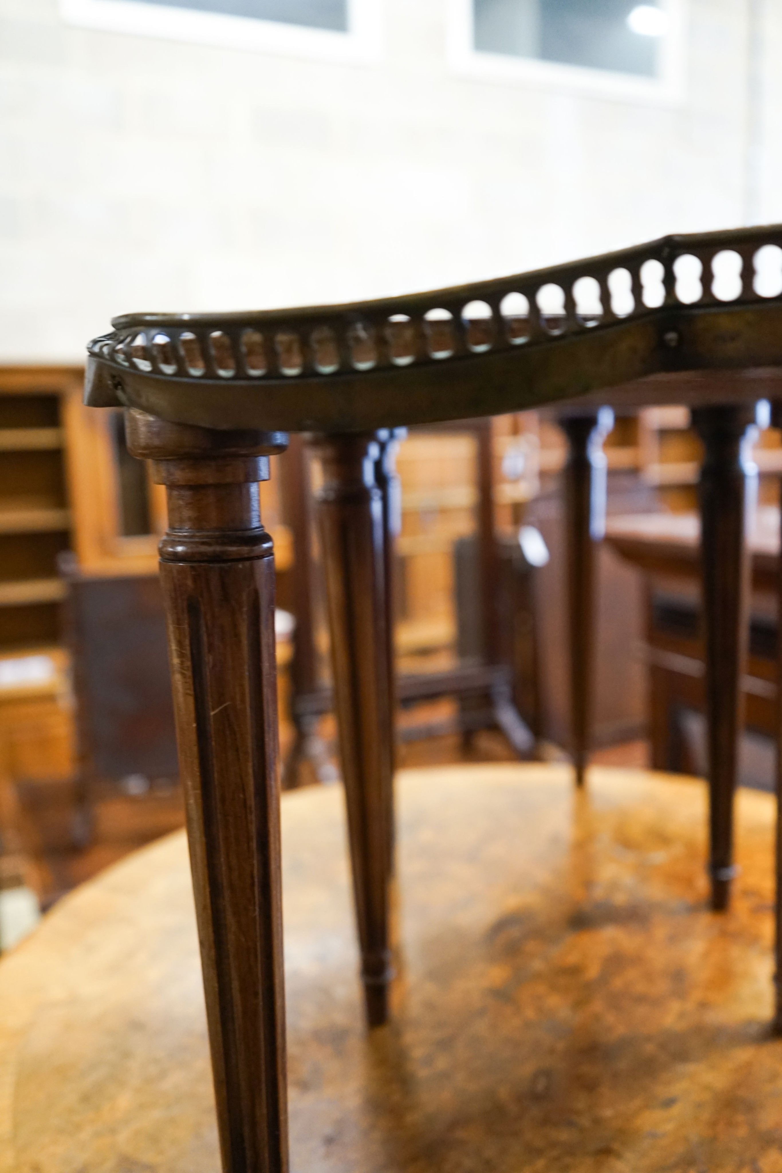 A circular burr walnut cabriole leg coffee table, diameter 84cm, height 47cm together with two Continental mahogany side tables with fretted brass galleries
